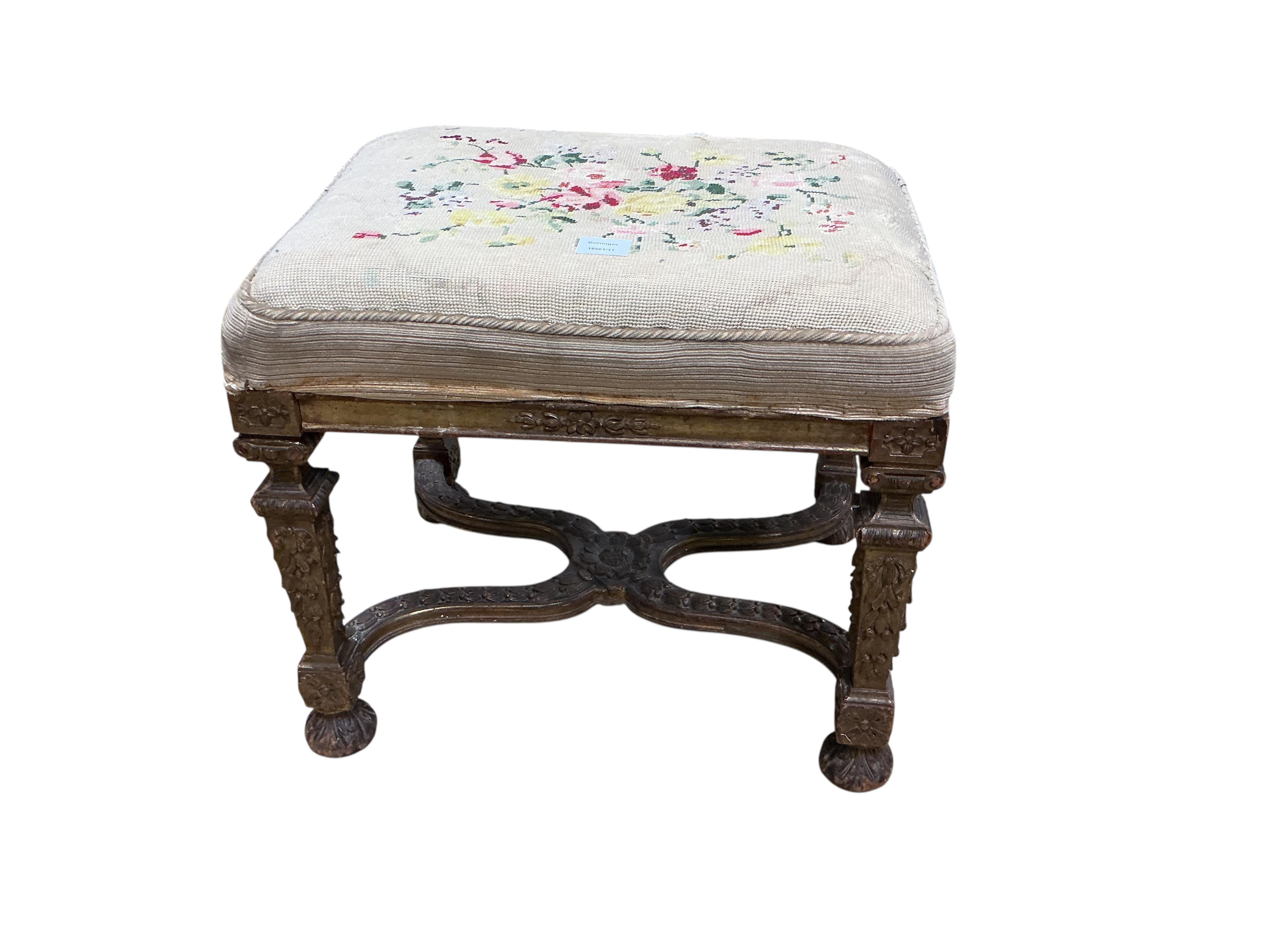 A 19th century carved giltwood dressing stool with shaped 'X' stretcher, width 56cm, depth 43cm, height 49cm